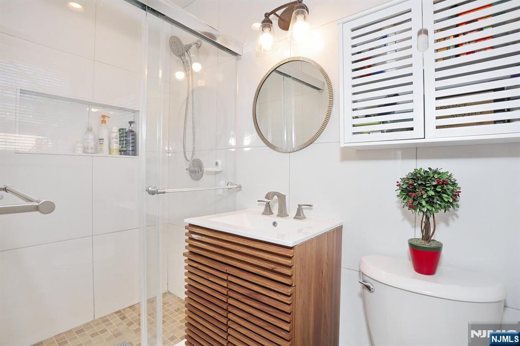 7 Tufts Court Paramus, NJ 07652 - Photo 20 of 50 a bathroom with a sink and a mirror
