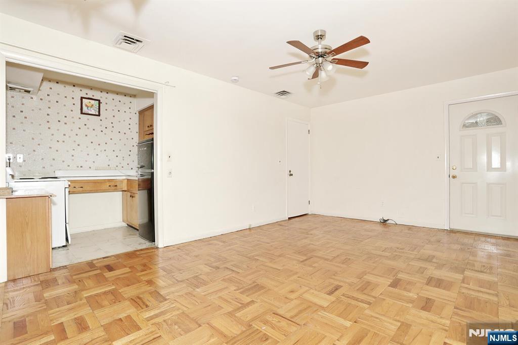 7 Tufts Court Paramus, NJ 07652 - Photo 28 of 50 a view of a workspace with wooden floor and a ceiling fan