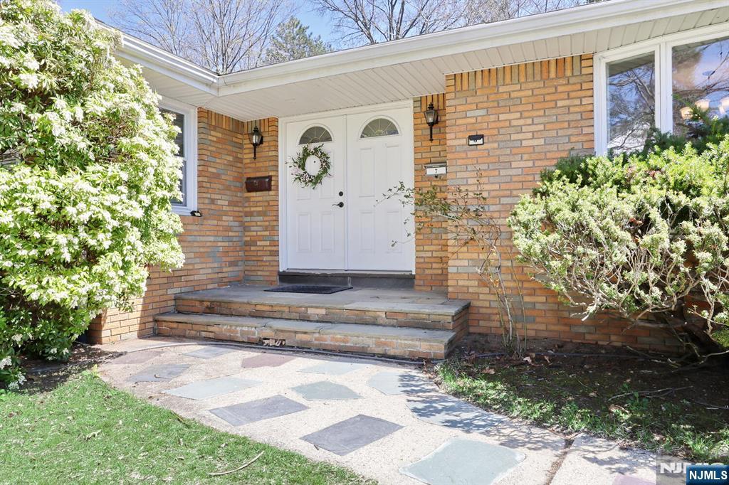 7 Tufts Court Paramus, NJ 07652 - Photo 3 of 50 a front view of a house with a garden