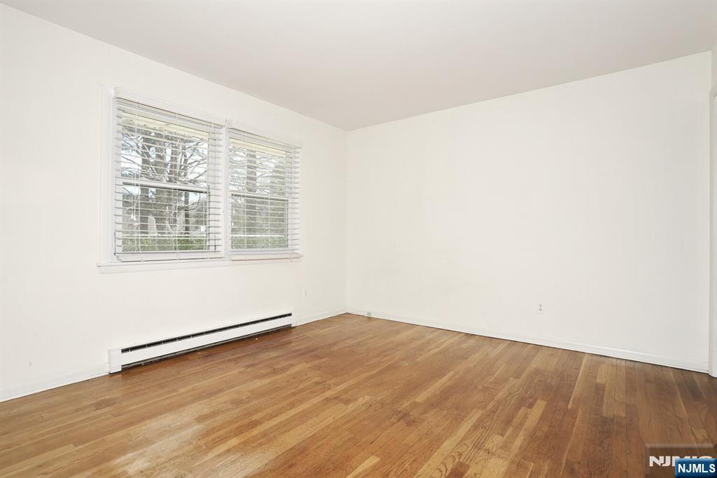 7 Tufts Court Paramus, NJ 07652 - Photo 31 of 50 an empty room with wooden floor and windows