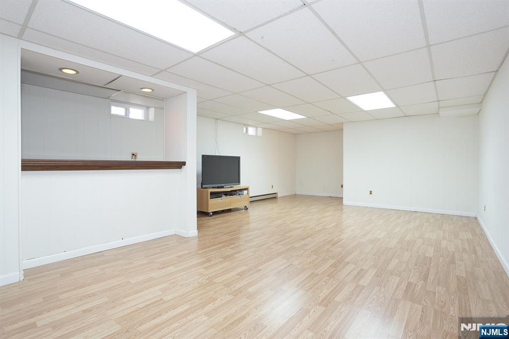 7 Tufts Court Paramus, NJ 07652 - Photo 38 of 50 a view of a livingroom with a piano and wooden floor