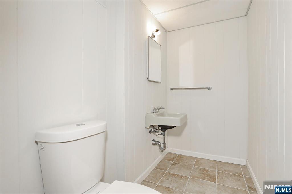 7 Tufts Court Paramus, NJ 07652 - Photo 40 of 50 a bathroom with a toilet a sink and mirror