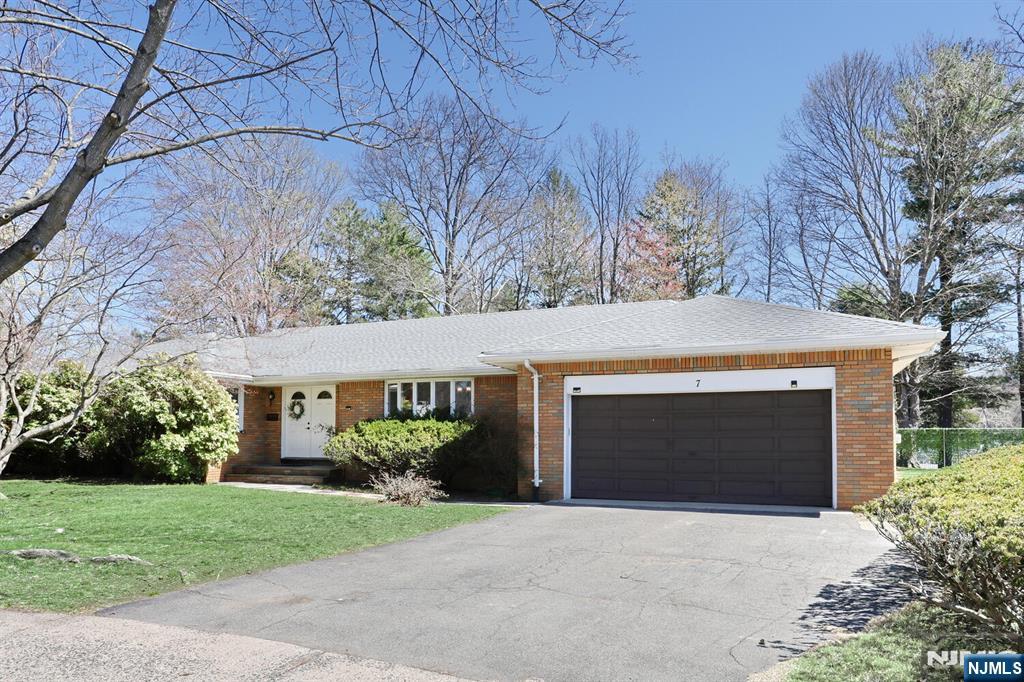 7 Tufts Court Paramus, NJ 07652 - Photo 41 of 50 a front view of a house with a yard and garage