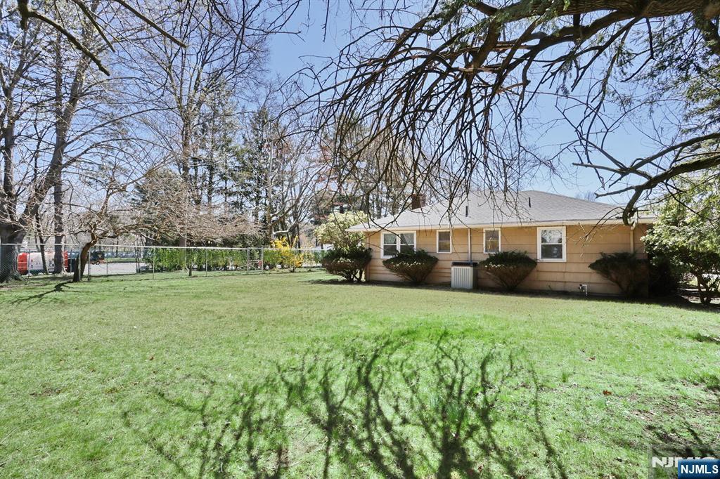 7 Tufts Court Paramus, NJ 07652 - Photo 43 of 50 a front view of a house with a yard and trees