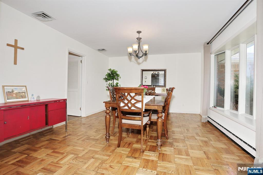 7 Tufts Court Paramus, NJ 07652 - Photo 8 of 50 a dining room with furniture a rug and a mirror