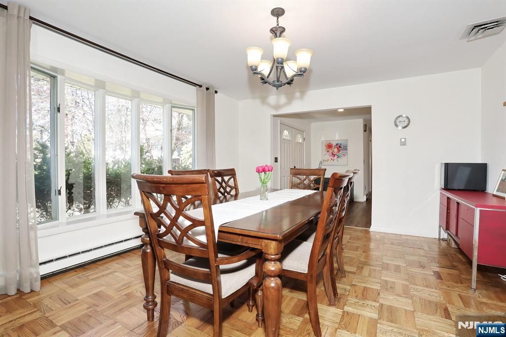 7 Tufts Court Paramus, NJ 07652 - Photo 9 of 50 a view of a dining room with furniture a chandelier and wooden floor