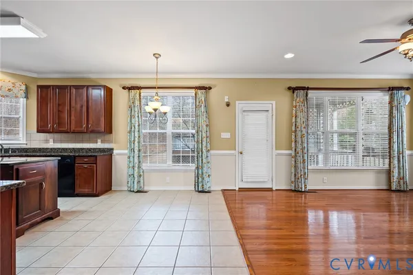 a view of a kitchen with granite countertop a stove top oven a sink a counter space and windows