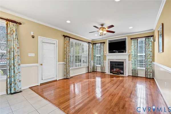 a view of livingroom with fireplace flat screen tv and windows