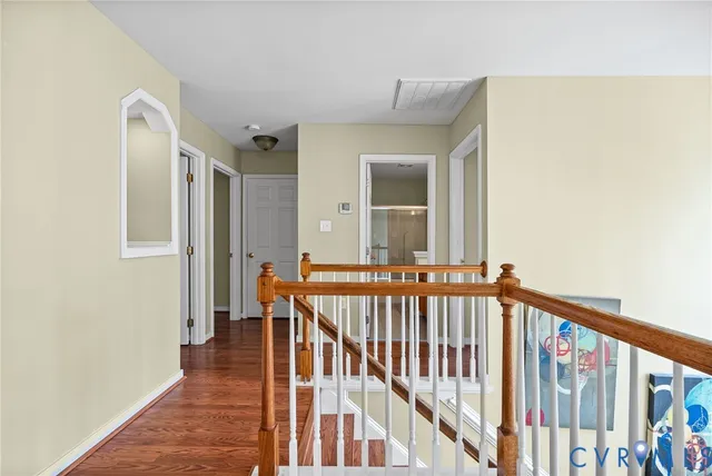 a view of an empty room with wooden floor
