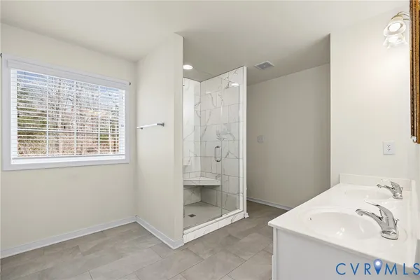 a bathroom with a shower sink and mirror