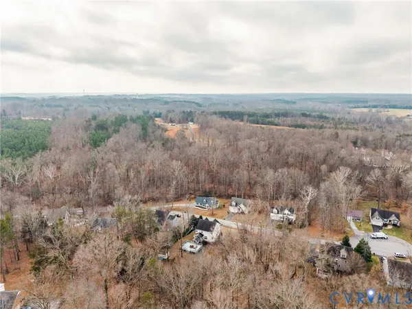 an aerial view of house with yard and mountain view in back