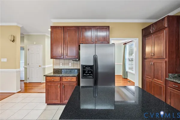 a kitchen with granite countertop stainless steel appliances and refrigerator
