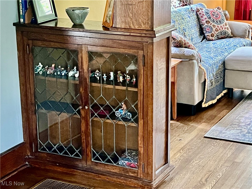 Built-in leaded glass bookcases between the living room and the formal dining room