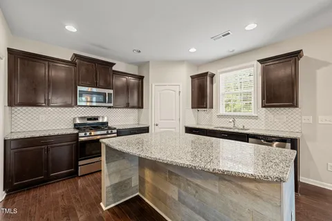 a kitchen with granite countertop stainless steel appliances and sink