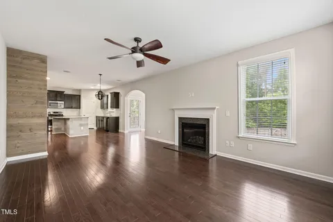 a view of empty room with wooden floor and fireplace