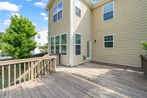 a view of balcony with wooden floor and fence