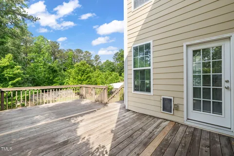 a view of a house with a deck and furniture