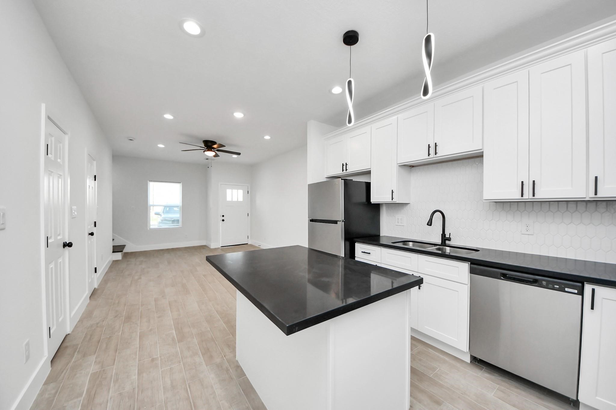 8015 Elbert Street, Unit A/B Houston, TX 77028 - Photo 6 of 12 a kitchen with stainless steel appliances granite countertop a sink a stove and a refrigerator