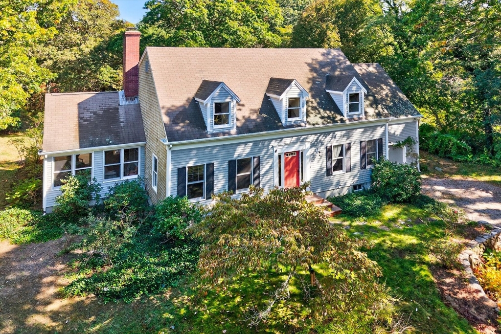 36 Tar Kiln Road Orleans, MA 02653 - Photo 2 of 42 a view of a white house with large windows and a small yard