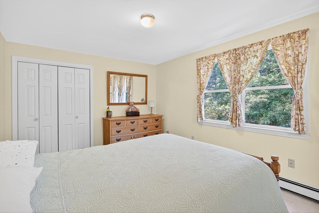 36 Tar Kiln Road Orleans, MA 02653 - Photo 36 of 42 a large bed sitting in a bedroom next to a window
