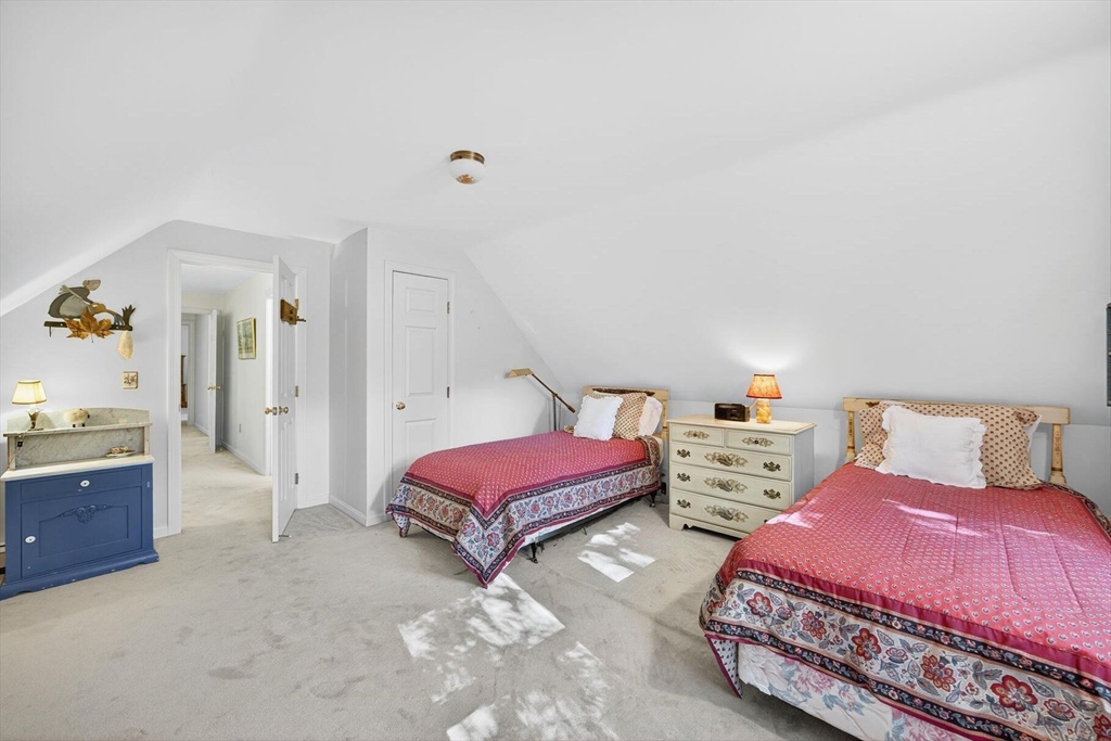 36 Tar Kiln Road Orleans, MA 02653 - Photo 37 of 42 a bedroom with two beds and a chandelier