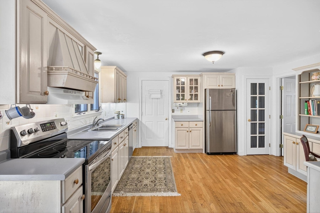 36 Tar Kiln Road Orleans, MA 02653 - Photo 7 of 42 a kitchen with stainless steel appliances granite countertop a refrigerator a stove and a wooden floors