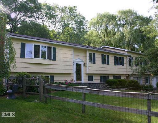 34 Sherwood Road Ridgefield, CT 06877 - Photo 1 of 1 a front view of house with yard and green space