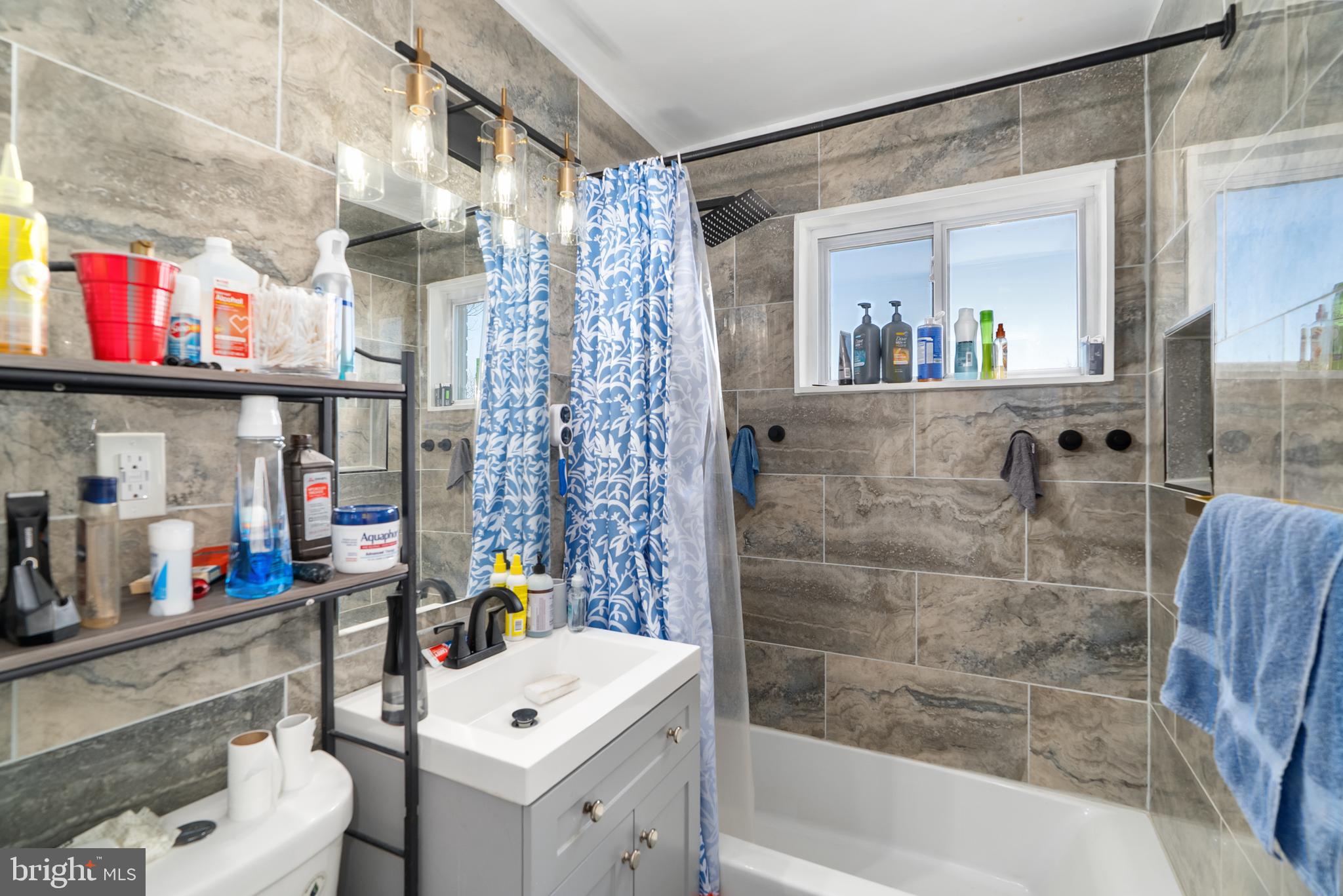 182 Joliet Street Washington, DC 20032 - Photo 20 of 49 a bathroom with a sink a toilet and a shower