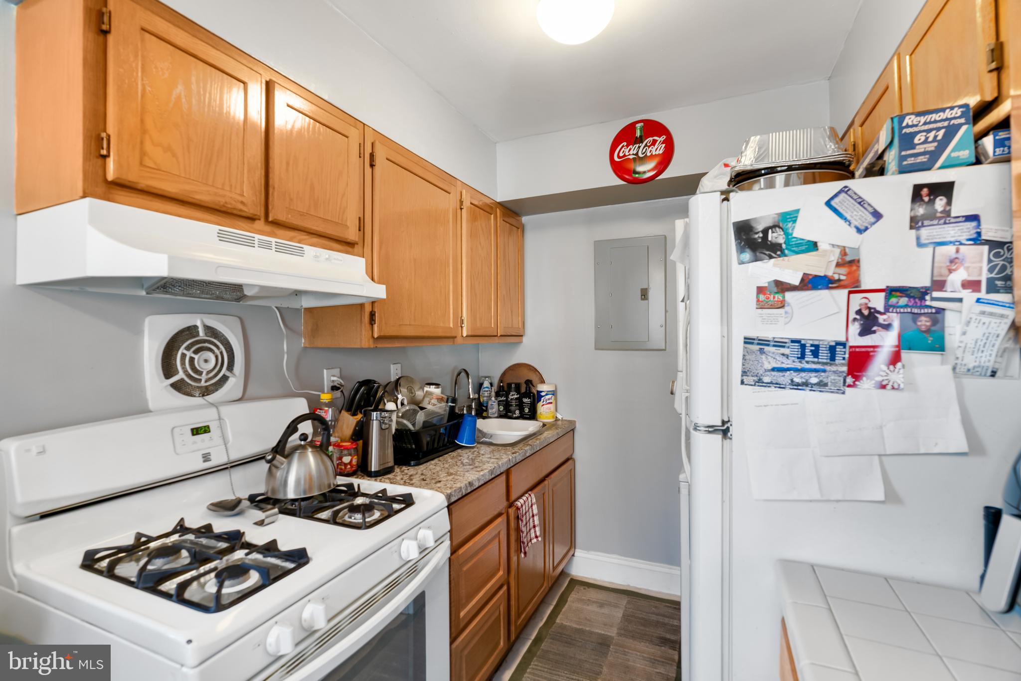 182 Joliet Street Washington, DC 20032 - Photo 27 of 49 a kitchen with a refrigerator a stove and a cabinets