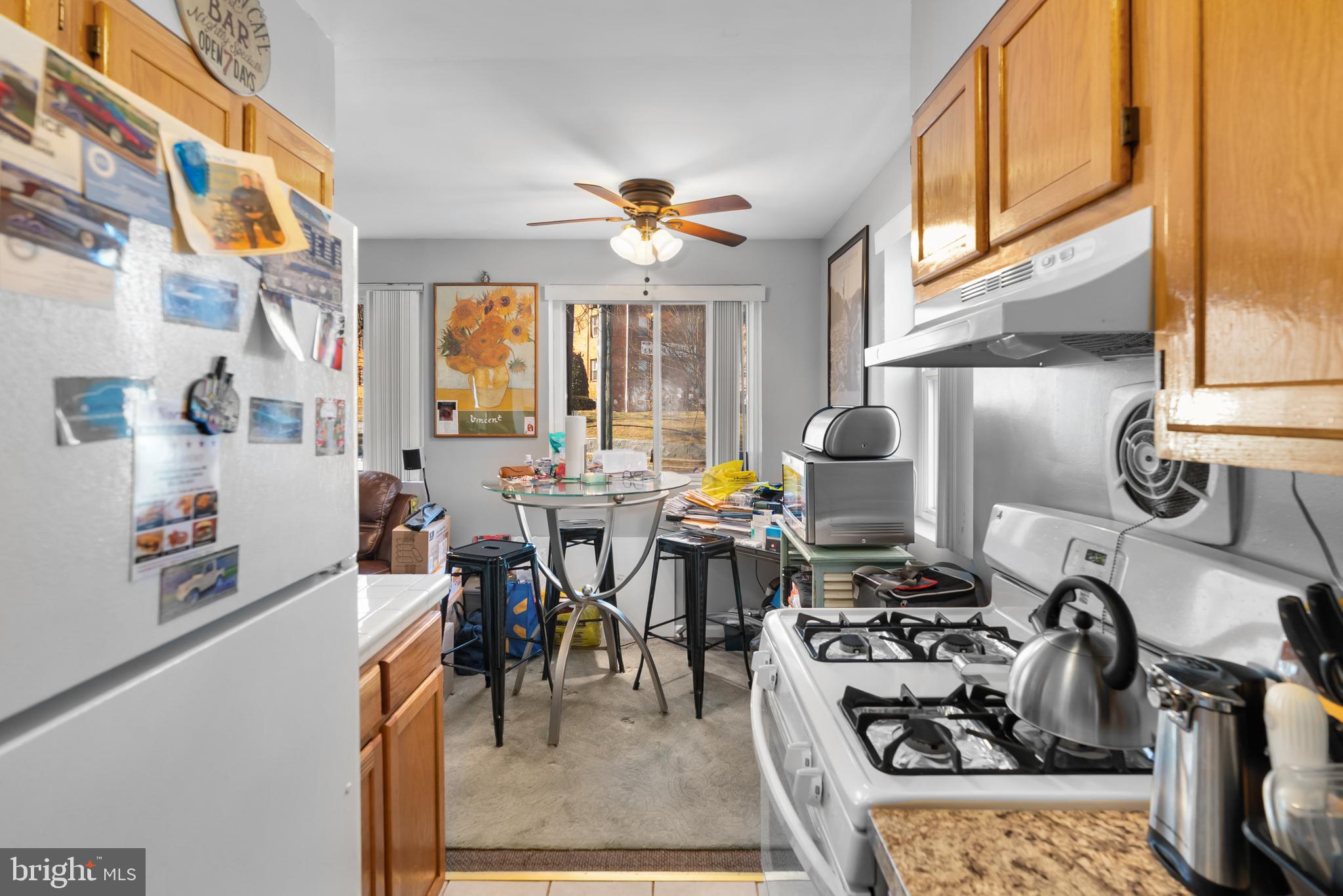 182 Joliet Street Washington, DC 20032 - Photo 28 of 49 a view of a dining hall with couches a dining table and chairs with the kitchen view