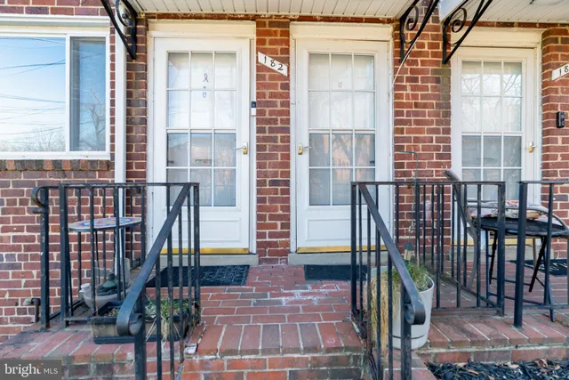 a view of a brick house with many windows