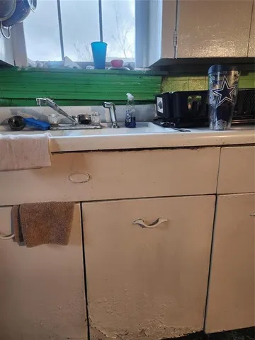 a kitchen with a sink and a refrigerator