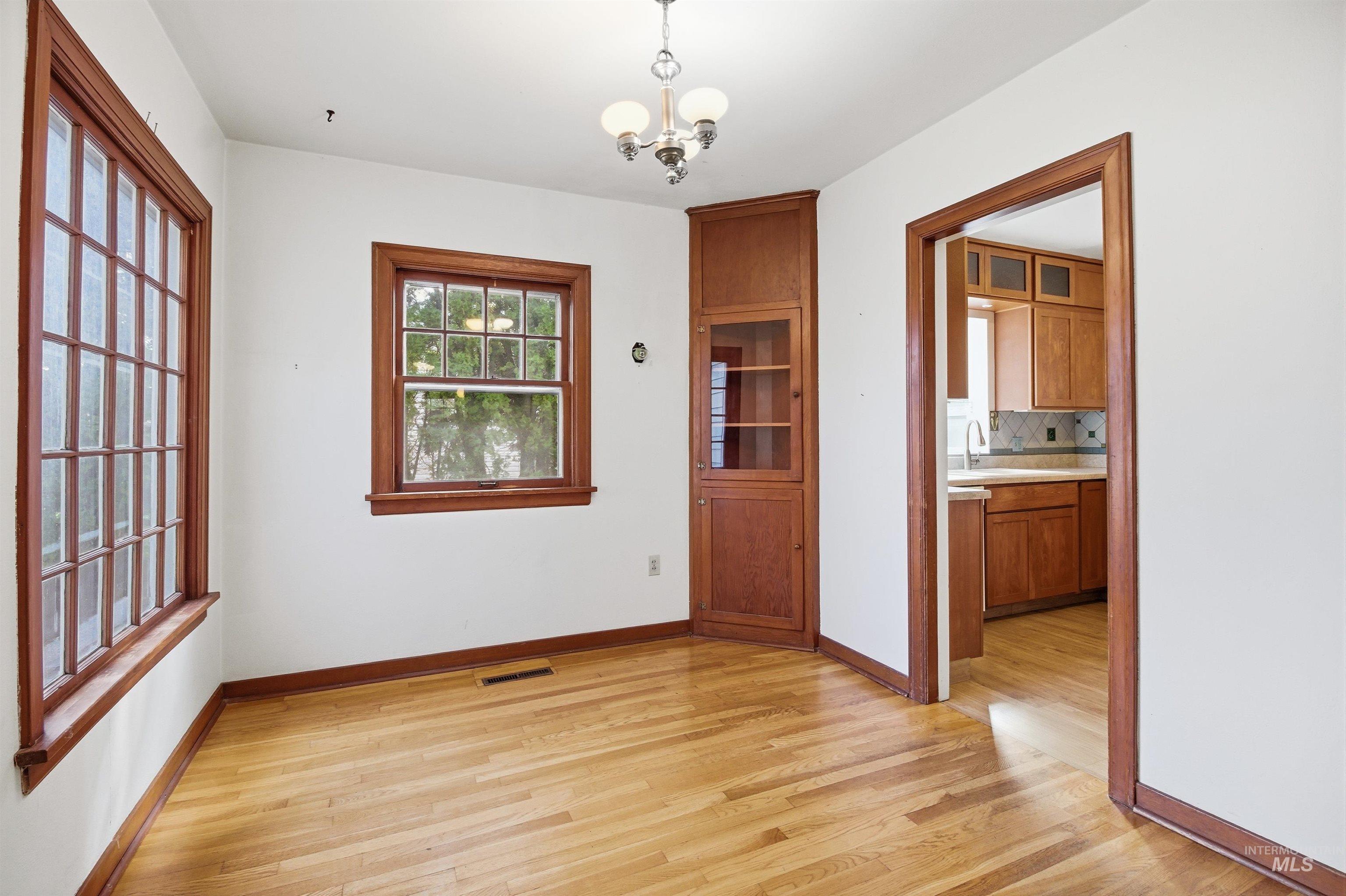 1117 East 6th Street Moscow, ID 83843 - Photo 19 of 46 Unfurnished dining area featuring hanging lights and light wood-style flooring