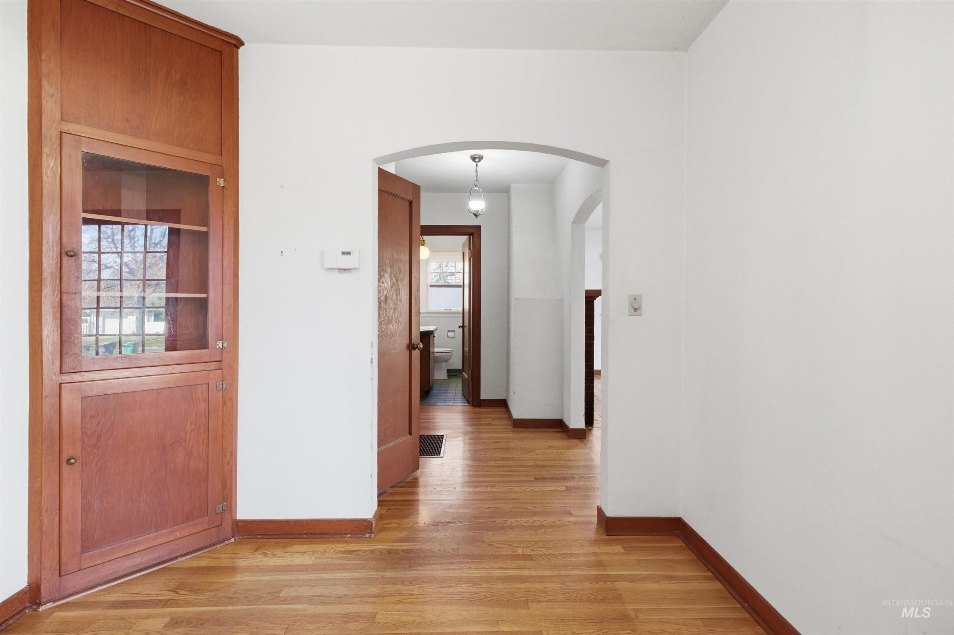 1117 East 6th Street Moscow, ID 83843 - Photo 20 of 46 Hall with arched walkways and light wood-type flooring