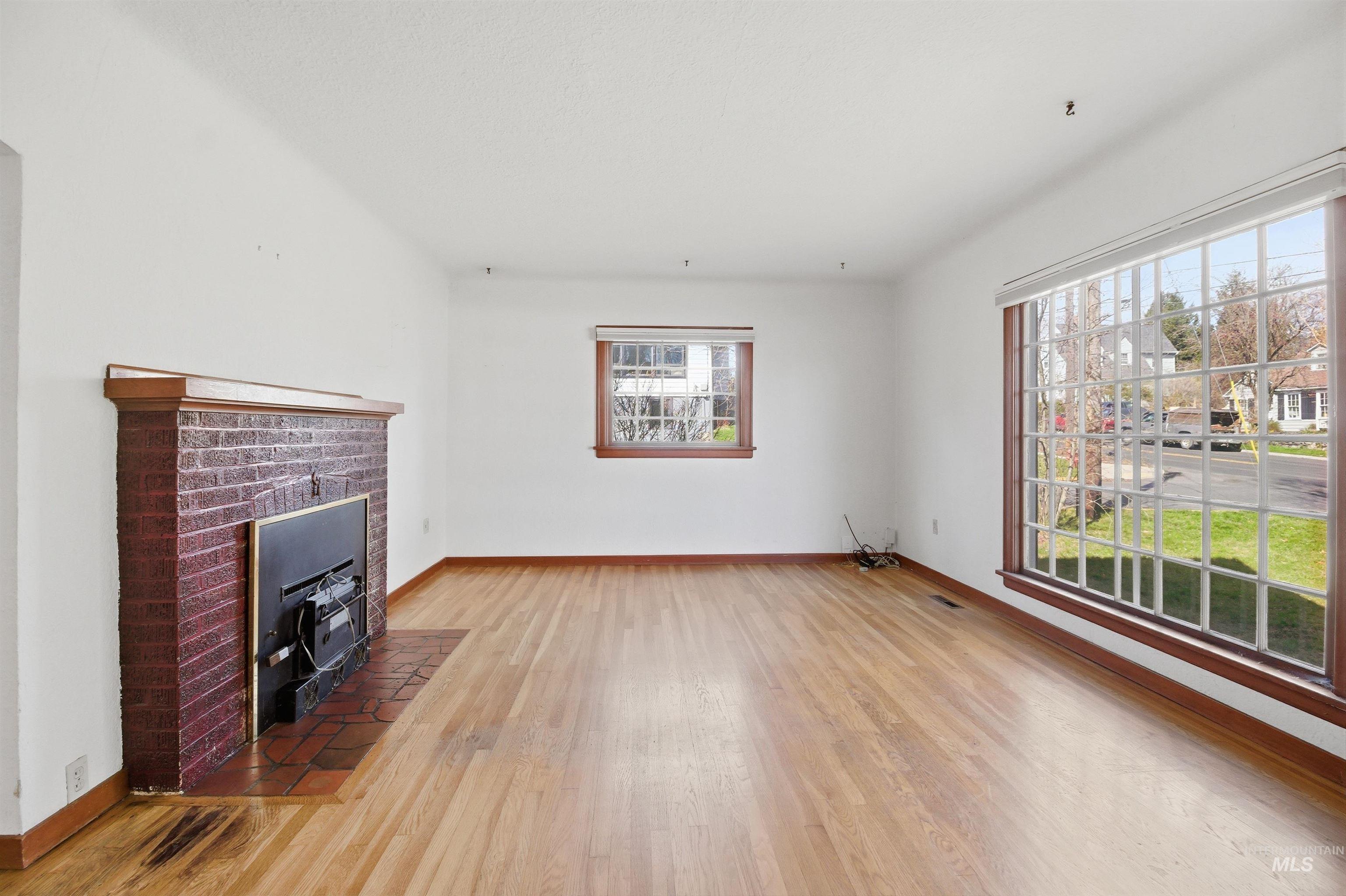 1117 East 6th Street Moscow, ID 83843 - Photo 22 of 46 Unfurnished living room featuring light wood finished floors and baseboards