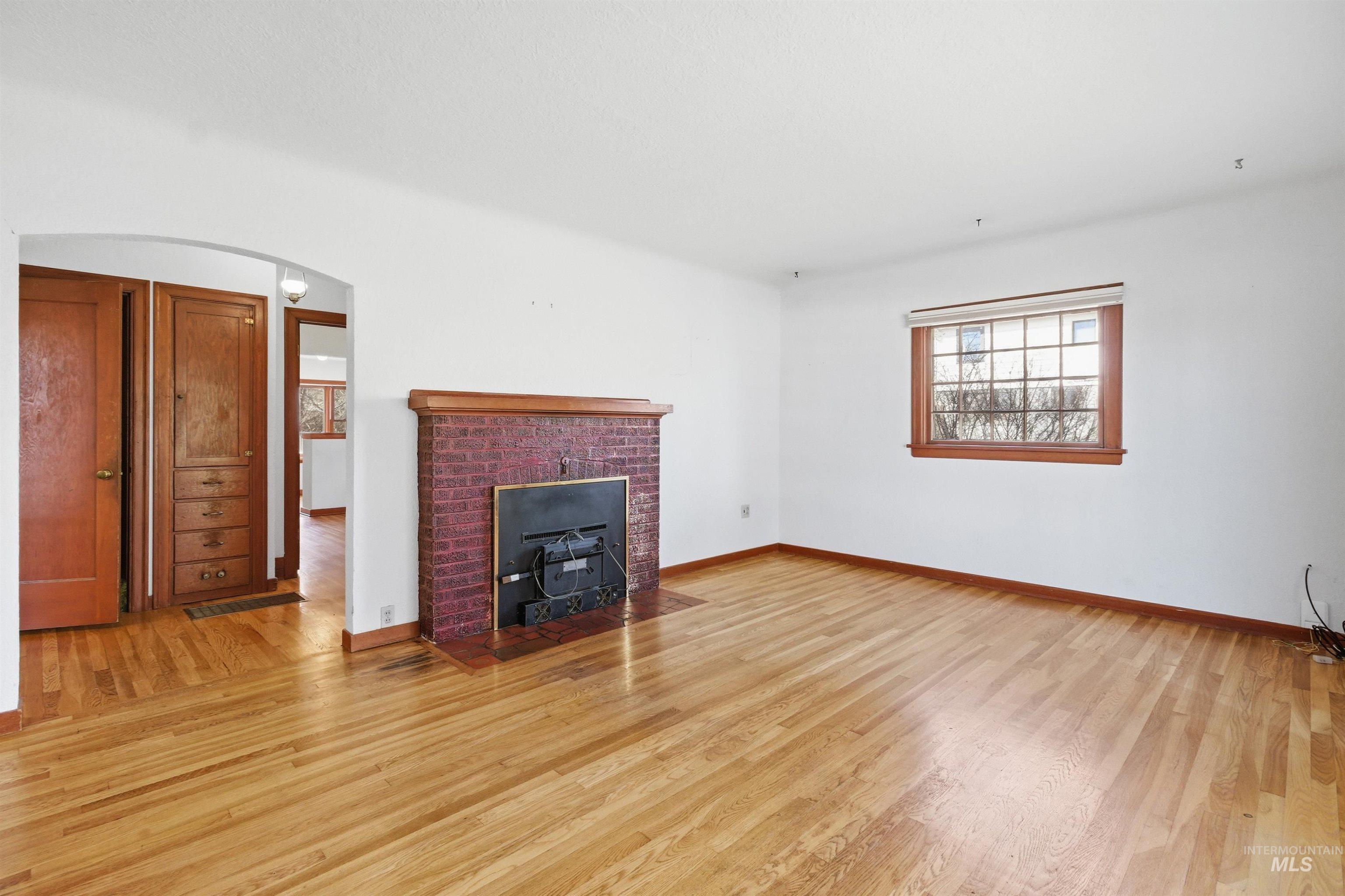 1117 East 6th Street Moscow, ID 83843 - Photo 23 of 46 Unfurnished living room with light wood-type flooring and arched walkways