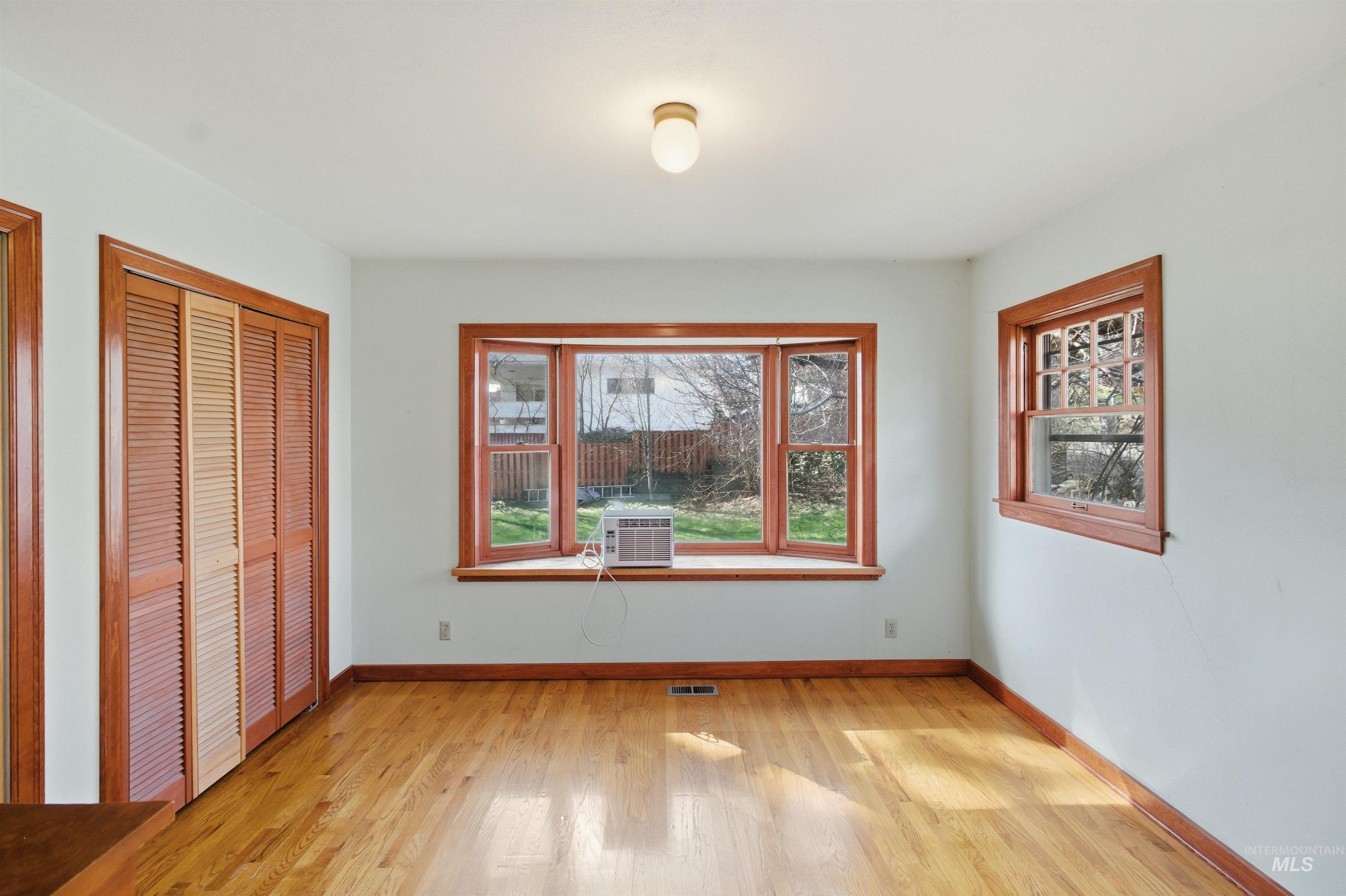 1117 East 6th Street Moscow, ID 83843 - Photo 30 of 46 Unfurnished bedroom with light wood-type flooring, multiple windows, and multiple closets