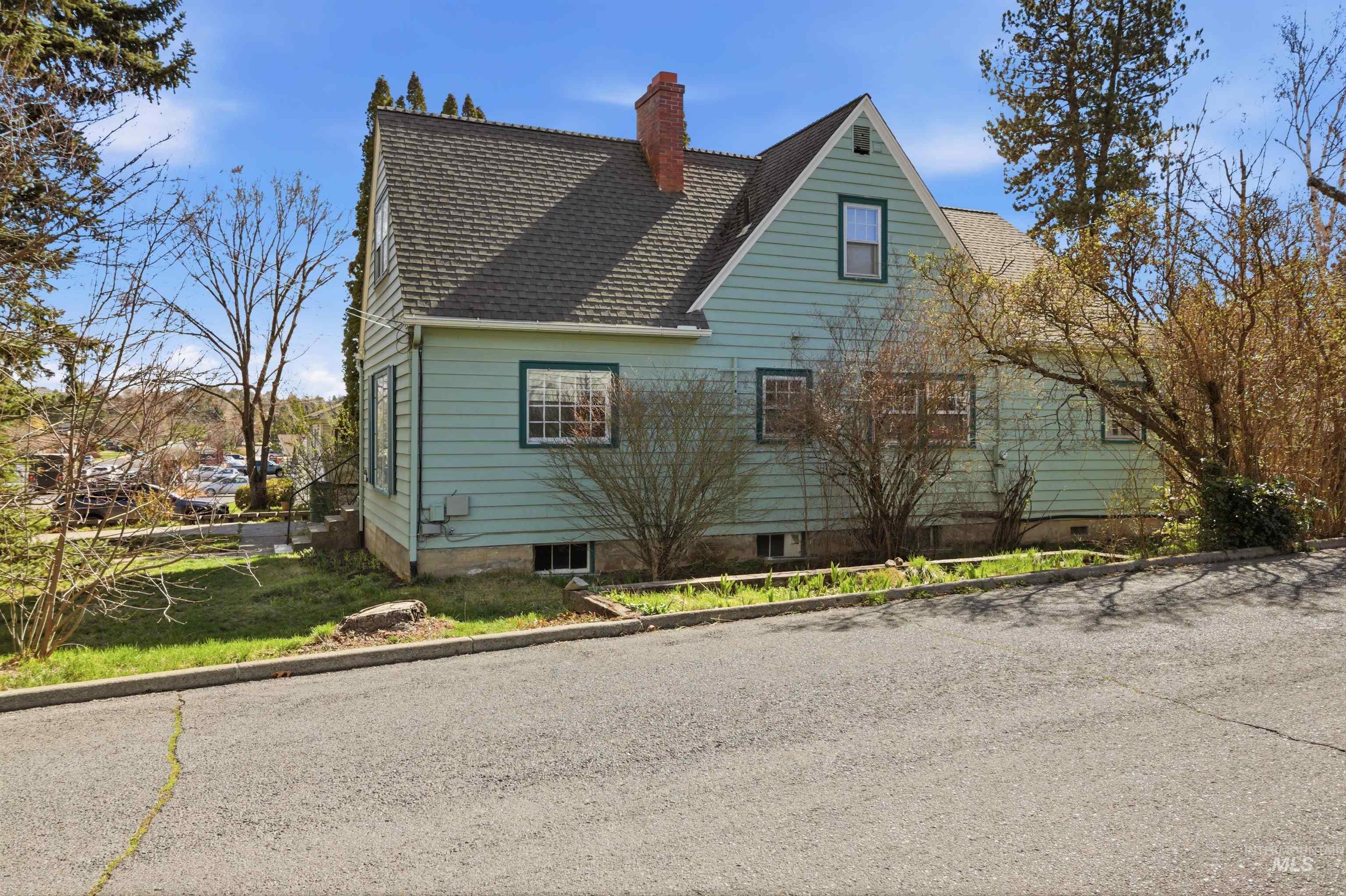 1117 East 6th Street Moscow, ID 83843 - Photo 3 of 46 View of home's exterior with roof with shingles and a chimney