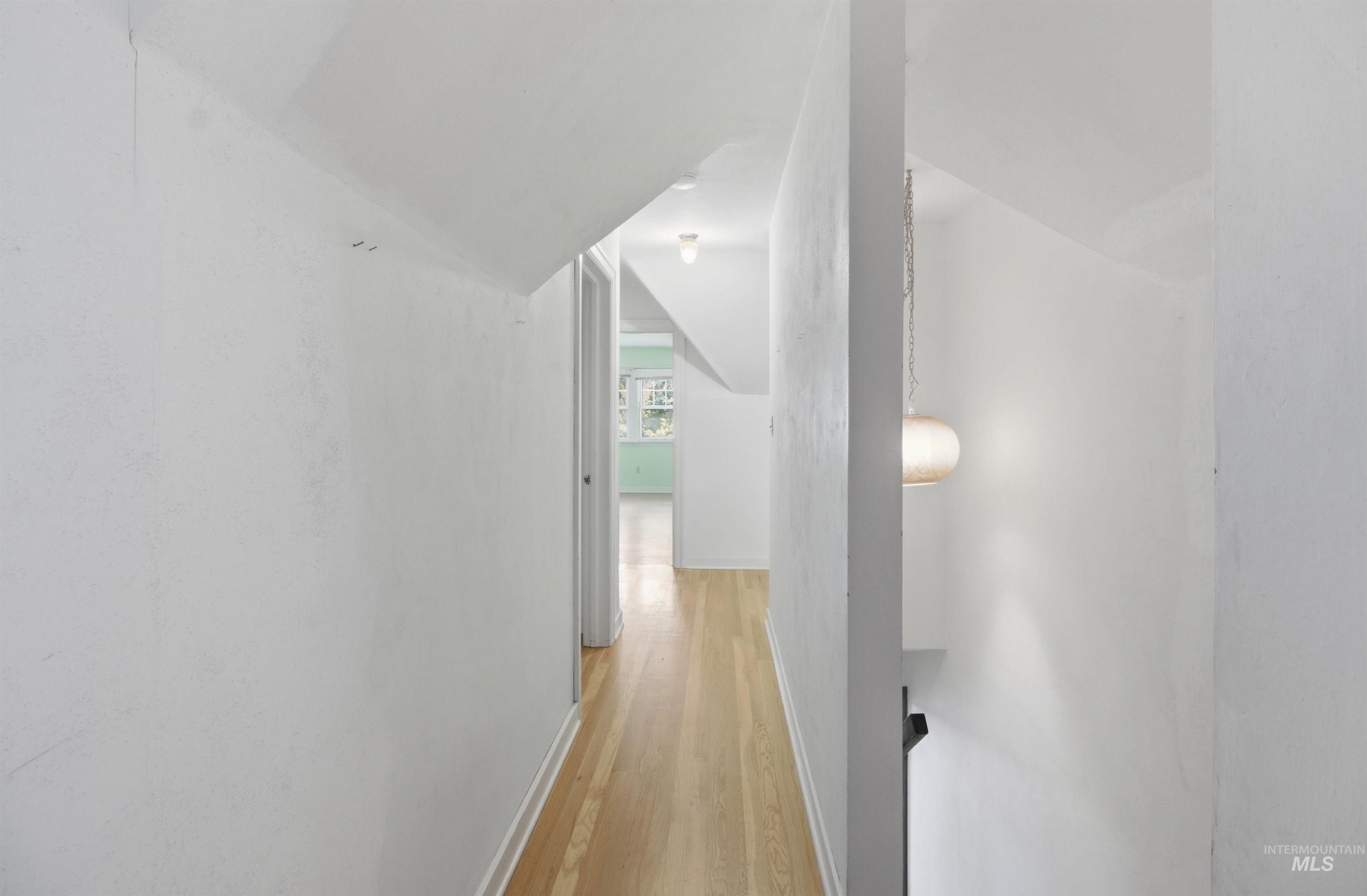 1117 East 6th Street Moscow, ID 83843 - Photo 35 of 46 Hallway with light wood-style floors and vaulted ceiling