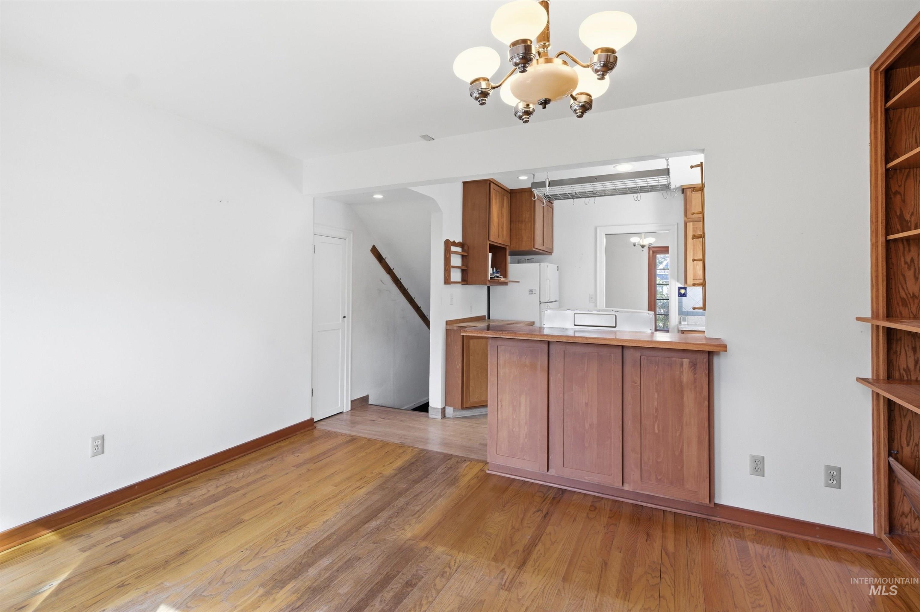 1117 East 6th Street Moscow, ID 83843 - Photo 46 of 46 Kitchen featuring open shelves, wood finish cabinets, light wood finished floors, a peninsula, and freestanding refrigerator