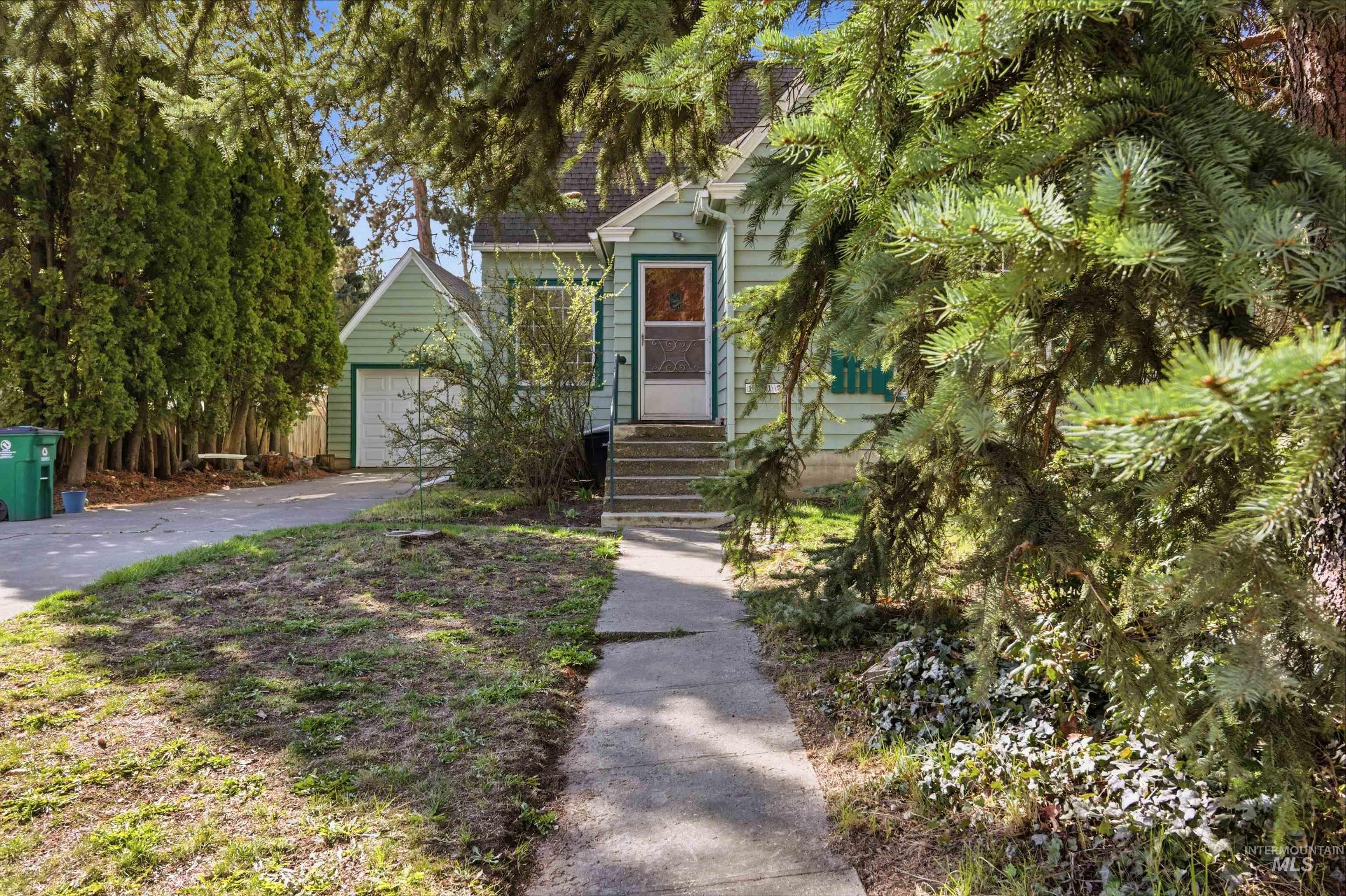 1117 East 6th Street Moscow, ID 83843 - Photo 5 of 46 Obstructed view of property with driveway, roof with shingles, and an outdoor structure
