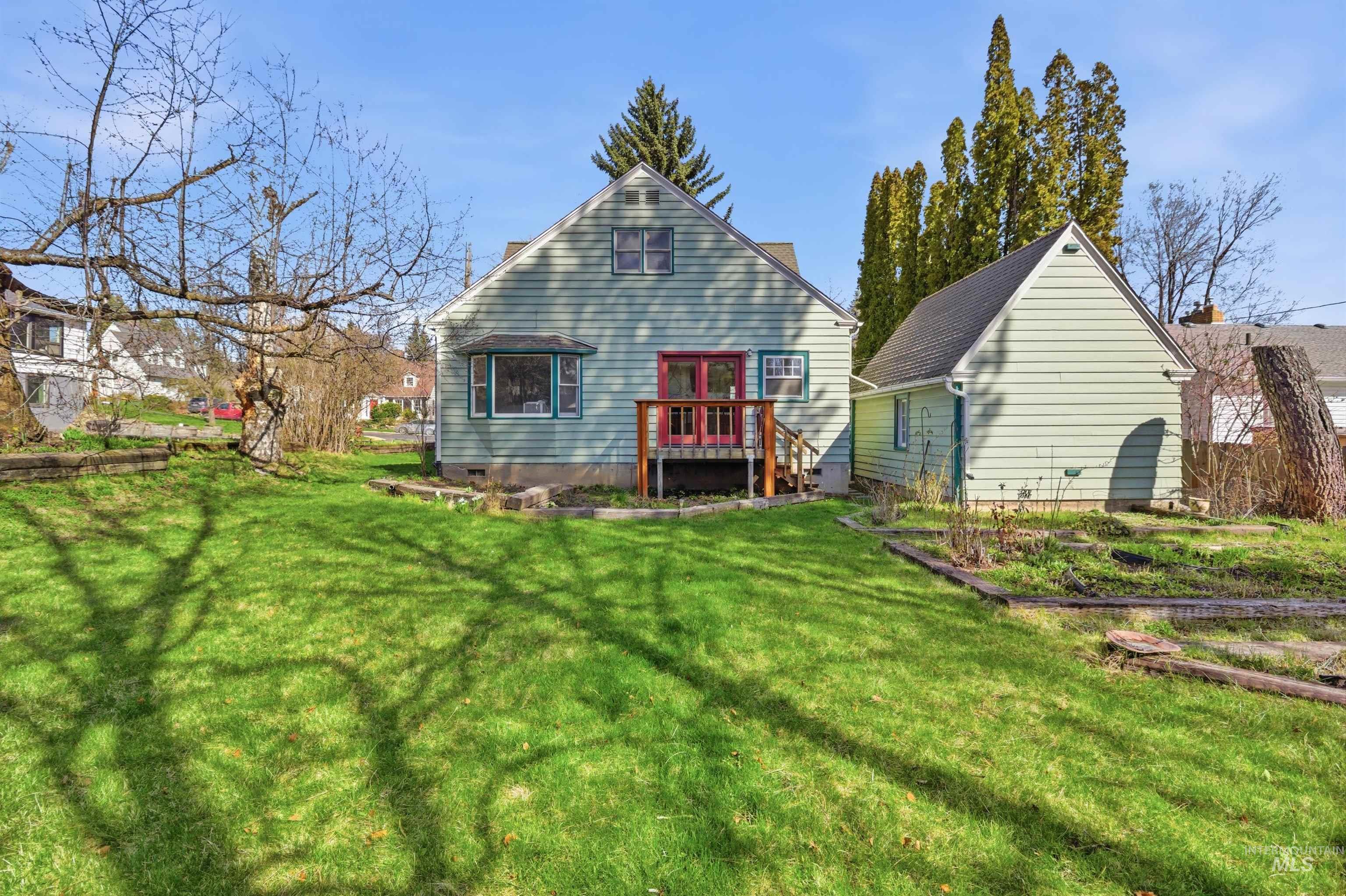 1117 East 6th Street Moscow, ID 83843 - Photo 7 of 46 Rear view of house with a yard and a vegetable garden