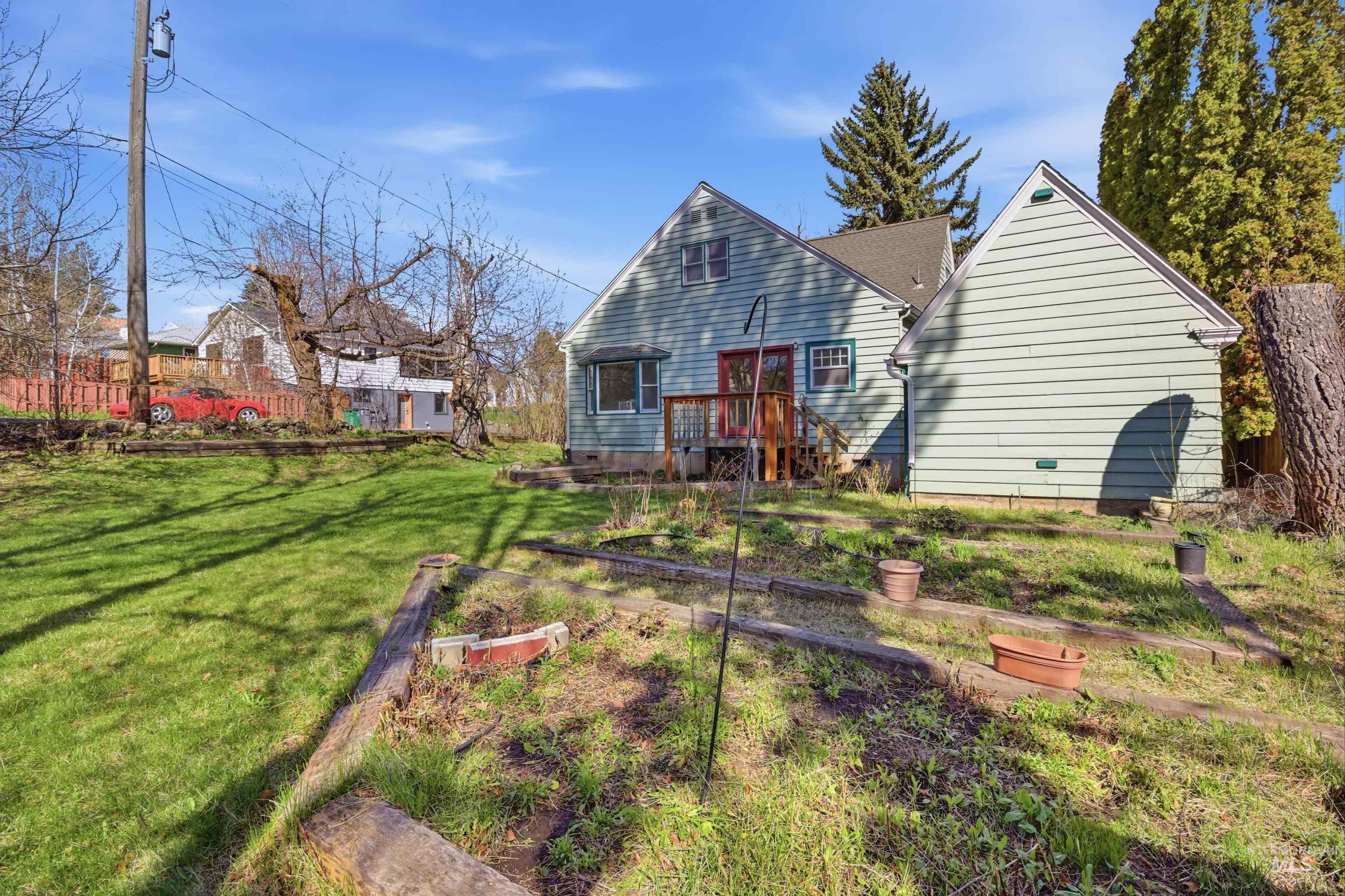1117 East 6th Street Moscow, ID 83843 - Photo 9 of 46 Rear view of house featuring a garden