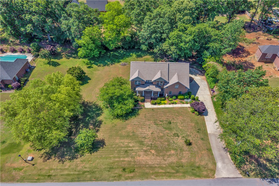 406 Hopewell Ridge Anderson, SC 29621 - Photo 3 of 46 This expansive property offers a private oasis with a traditional residence nestled amongst lush greenery.