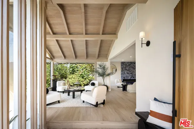 a bedroom with a large bed wooden floor and window