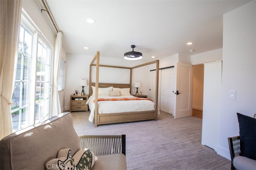 32052 Via Alicia San Juan Capistrano, CA 92675 - Photo 17 of 39 a bedroom with a large bed and a chandelier