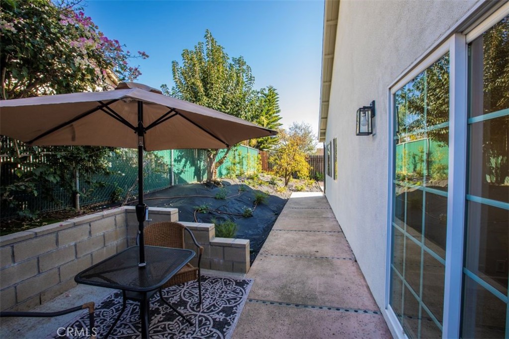32052 Via Alicia San Juan Capistrano, CA 92675 - Photo 26 of 39 a backyard of a house with table and chairs under an umbrella