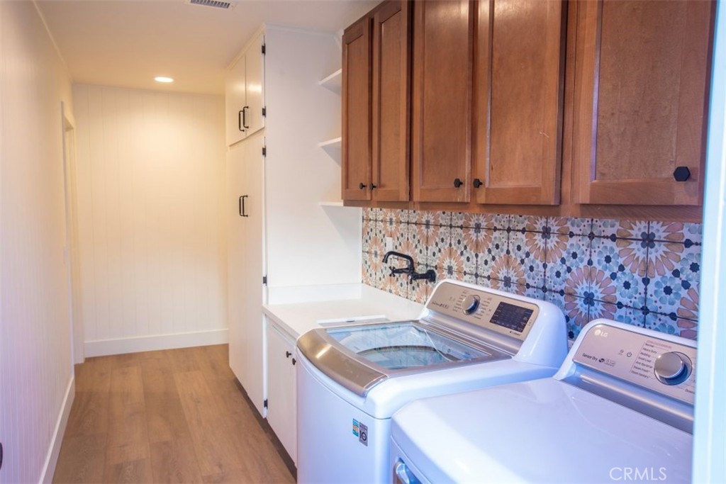32052 Via Alicia San Juan Capistrano, CA 92675 - Photo 31 of 39 a hallway with a stove top oven a sink and dishwasher