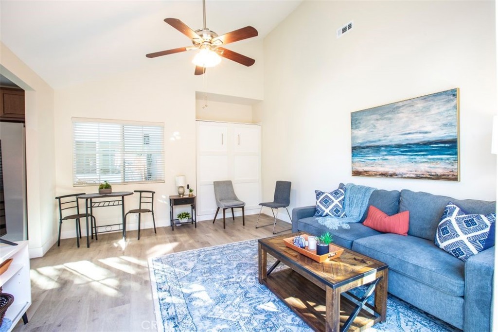 32052 Via Alicia San Juan Capistrano, CA 92675 - Photo 35 of 39 a living room with furniture a table and a large window