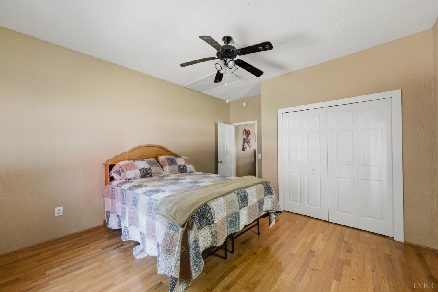 809 Plantation Road Amherst, VA 24521 - Photo 12 of 77 a bedroom with a bed and wooden floor